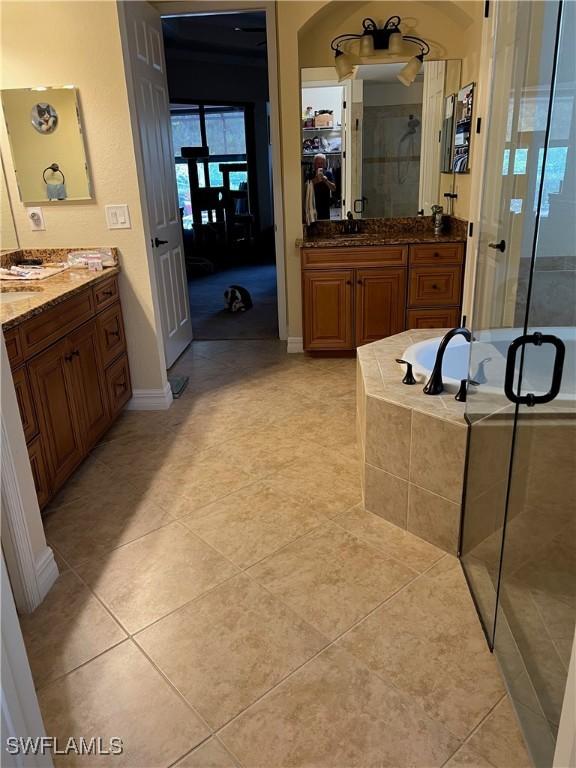 11010 Longwing Dr, Fort Myers, FL 33912 - bathroom featuring a stall shower, tile patterned flooring, vanity, and baseboards