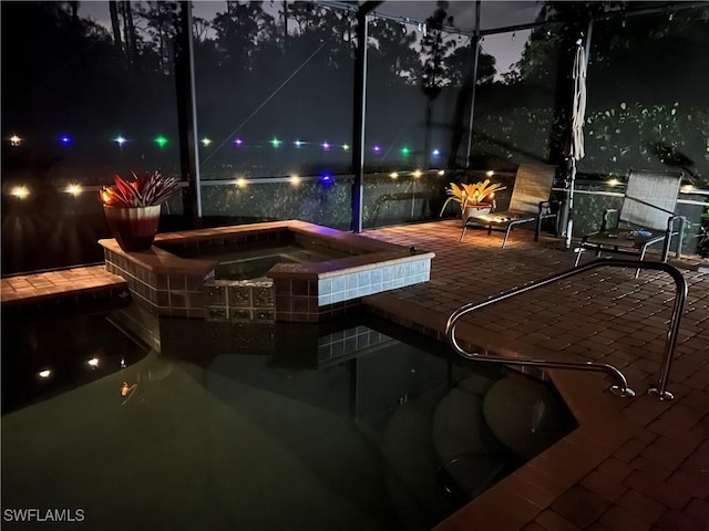 11010 Longwing Dr, Fort Myers, FL 33912 - pool at night with an in-ground hot tub, a patio area, a lanai, and an outdoor pool