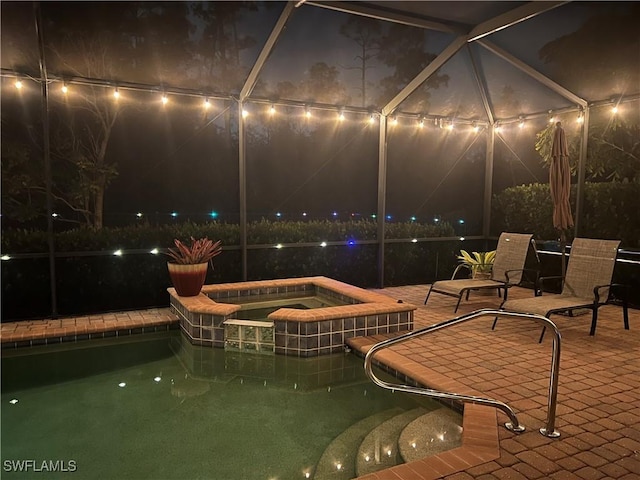 11010 Longwing Dr, Fort Myers, FL 33912 - patio at night with a patio, a lanai, and a pool with connected hot tub