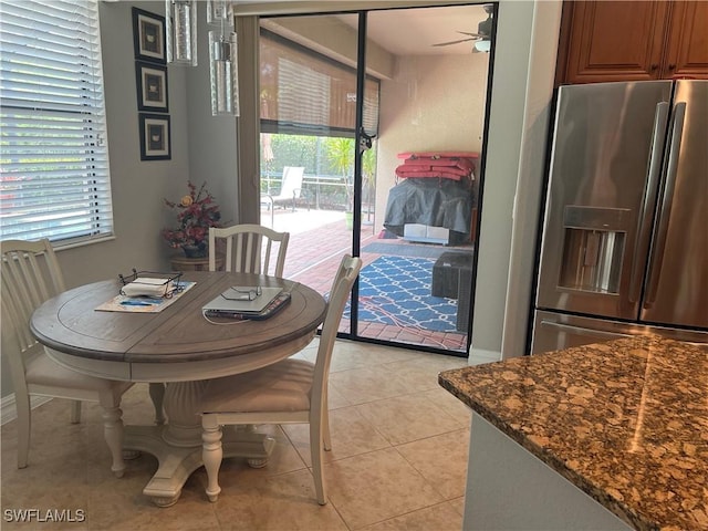 11010 Longwing Dr, Fort Myers, FL 33912 - dining space with ceiling fan, healthy amount of natural light, light tile patterned flooring, and baseboards