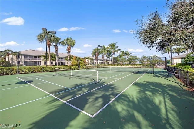 view of tennis court with community basketball court