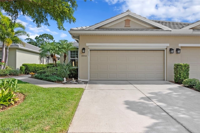 view of front of home with stucco siding, concrete driveway, and a garage