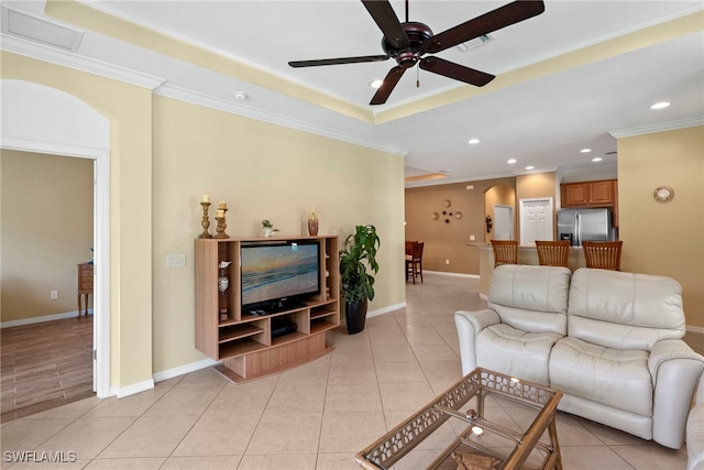 living area featuring a ceiling fan, arched walkways, crown molding, recessed lighting, and light tile patterned flooring