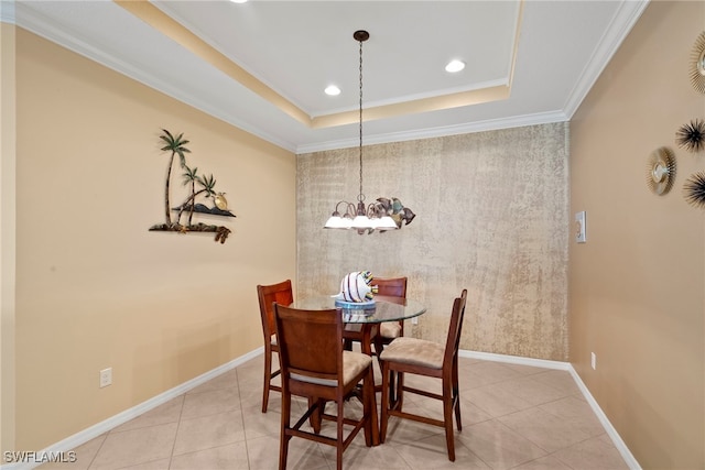 dining area featuring a chandelier, tile patterned floors, an accent wall, recessed lighting, and a tray ceiling