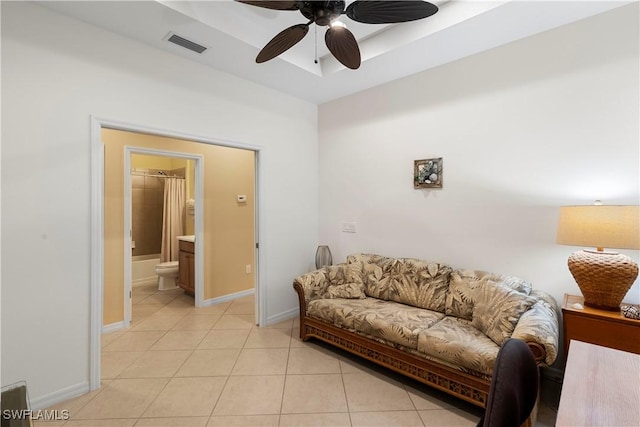 living area featuring a ceiling fan and light tile patterned flooring