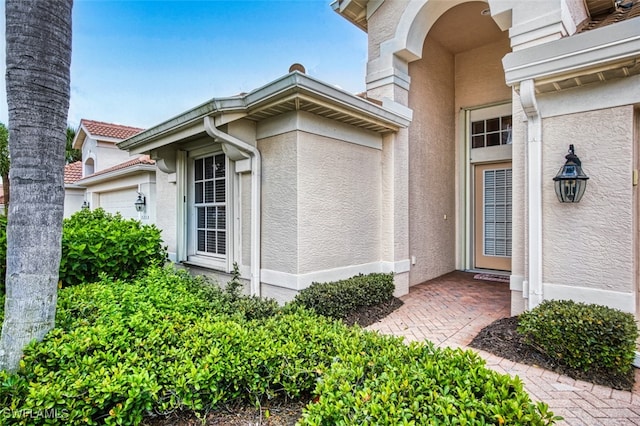 9211 Independence Way, Fort Myers, FL 33913 - property entrance featuring stucco siding and an attached garage