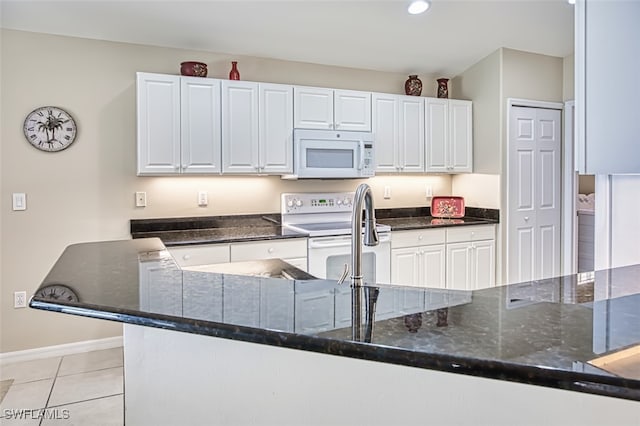 9211 Independence Way, Fort Myers, FL 33913 - kitchen featuring white appliances, light tile patterned floors, white cabinets, dark stone counters, and recessed lighting