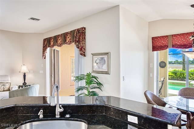 9211 Independence Way, Fort Myers, FL 33913 - kitchen with lofted ceiling and dark stone countertops