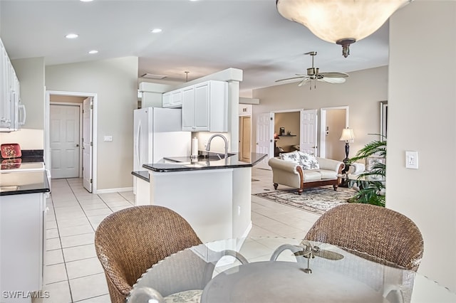 9211 Independence Way, Fort Myers, FL 33913 - kitchen with light tile patterned flooring, dark countertops, white cabinets, a ceiling fan, and white appliances