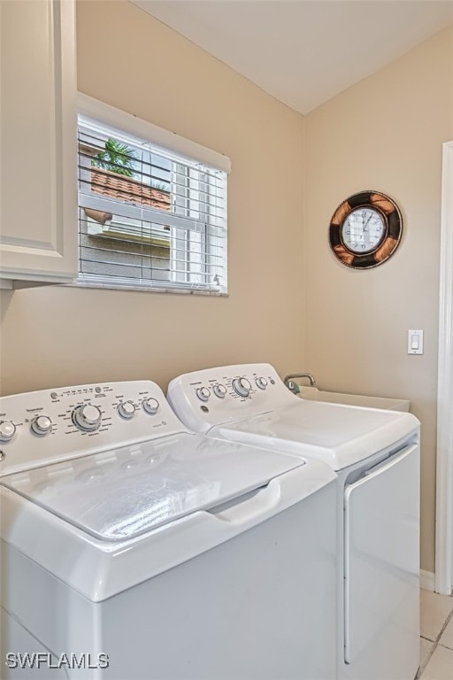9211 Independence Way, Fort Myers, FL 33913 - washroom with cabinet space, washer and clothes dryer, and light tile patterned floors