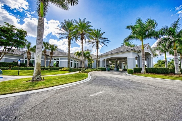 9211 Independence Way, Fort Myers, FL 33913 - view of front of home with stucco siding, a front yard, and a tile roof