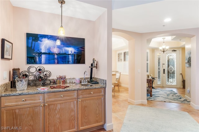 11600 Court Of Palms Unit 301, Fort Myers, FL 33908 - indoor bar featuring arched walkways, light tile patterned floors, pendant lighting, and a chandelier