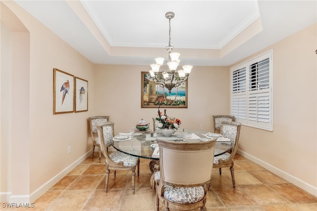 11600 Court Of Palms Unit 301, Fort Myers, FL 33908 - dining area with a raised ceiling, crown molding, a chandelier, arched walkways, and stone finish floors