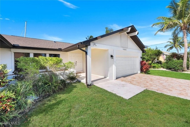 1528 SW 52nd Ln, Cape Coral, FL 33914 - view of home's exterior featuring stucco siding, a lawn, and an attached garage