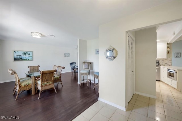 1528 SW 52nd Ln, Cape Coral, FL 33914 - dining space featuring light wood-style flooring and baseboards
