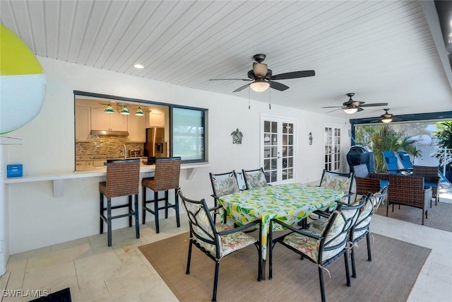 1528 SW 52nd Ln, Cape Coral, FL 33914 - view of patio / terrace featuring a bar, french doors, ceiling fan, and outdoor dining area