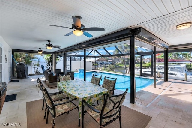 1528 SW 52nd Ln, Cape Coral, FL 33914 - view of patio with a ceiling fan, an outdoor pool, glass enclosure, outdoor dining area, and a grill