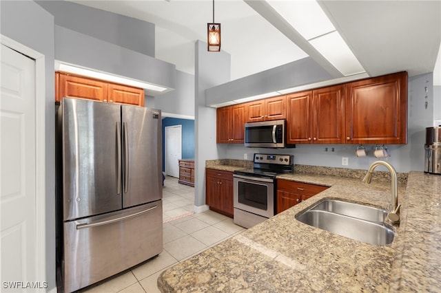 1226 SW 15th Ter, Cape Coral, FL 33991 - kitchen with appliances with stainless steel finishes, light tile patterned floors, light stone countertops, brown cabinetry, and a high ceiling