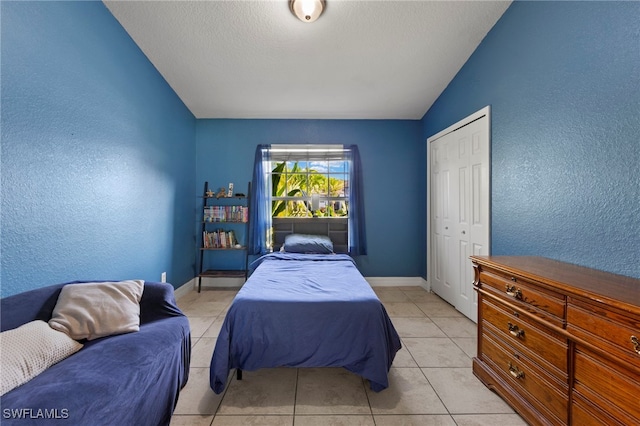 1226 SW 15th Ter, Cape Coral, FL 33991 - bedroom with a textured wall, lofted ceiling, light tile patterned floors, and a closet