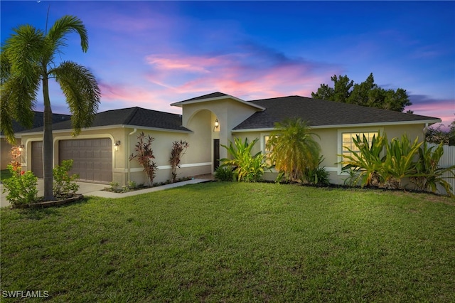 1226 SW 15th Ter, Cape Coral, FL 33991 - view of front of house with an attached garage, a lawn, stucco siding, and driveway