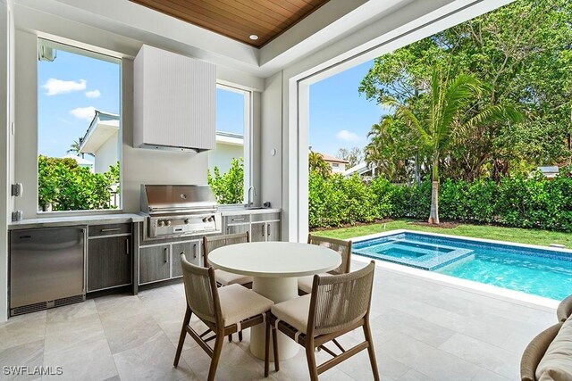 777 Broad Ct S, Naples, FL 34102 - view of swimming pool featuring a patio, outdoor dining space, a sink, and an in-ground hot tub