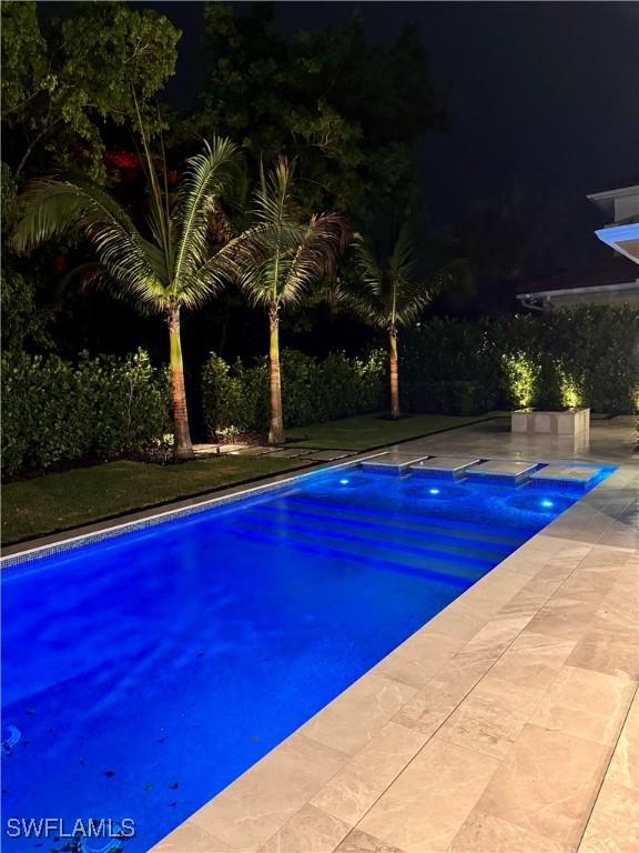 777 Broad Ct S, Naples, FL 34102 - pool at night with an outdoor pool