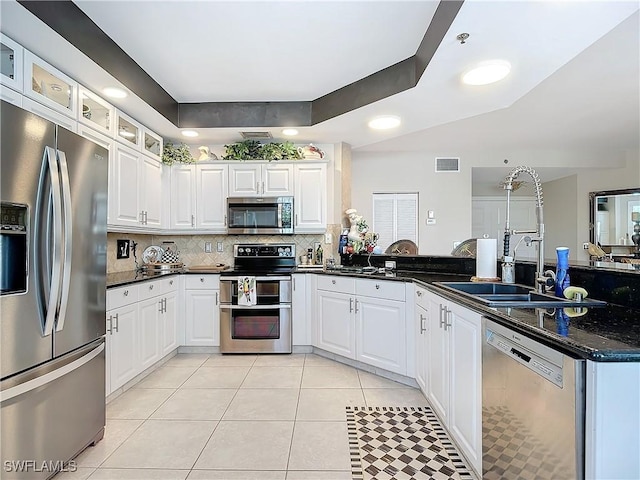 1131 Swallow Ave Unit 3-202, Marco Island, FL 34145 - kitchen featuring appliances with stainless steel finishes, light tile patterned flooring, white cabinets, a peninsula, and recessed lighting