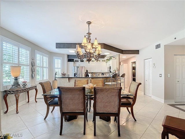 1131 Swallow Ave Unit 3-202, Marco Island, FL 34145 - dining area featuring a chandelier and light tile patterned floors