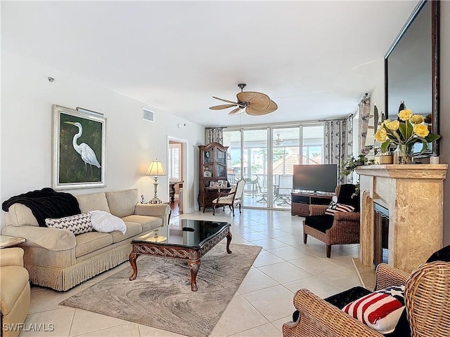 1131 Swallow Ave Unit 3-202, Marco Island, FL 34145 - living room featuring light tile patterned flooring, ceiling fan, expansive windows, and a glass covered fireplace