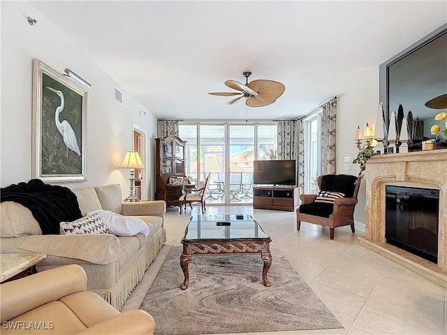 1131 Swallow Ave Unit 3-202, Marco Island, FL 34145 - living room featuring light tile patterned floors, ceiling fan, and a premium fireplace