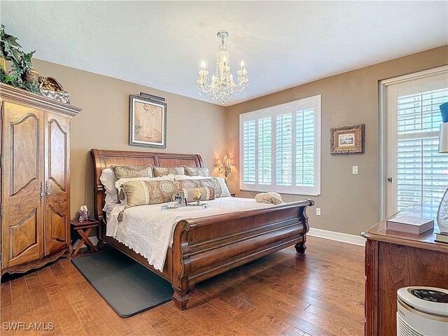 1131 Swallow Ave Unit 3-202, Marco Island, FL 34145 - bedroom featuring a chandelier and light wood-style flooring