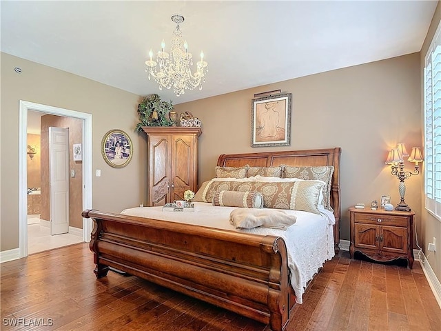 1131 Swallow Ave Unit 3-202, Marco Island, FL 34145 - bedroom with hardwood / wood-style flooring, a chandelier, and ensuite bath