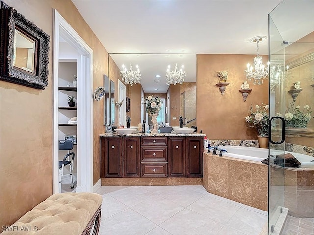 1131 Swallow Ave Unit 3-202, Marco Island, FL 34145 - bathroom featuring a chandelier, a garden tub, a stall shower, and double vanity