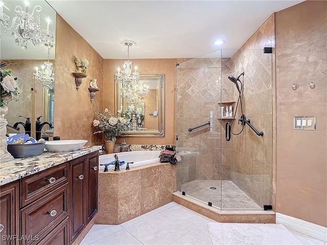 1131 Swallow Ave Unit 3-202, Marco Island, FL 34145 - full bathroom with a garden tub, a stall shower, vanity, a chandelier, and tile patterned floors