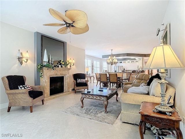 1131 Swallow Ave Unit 3-202, Marco Island, FL 34145 - living room with a high end fireplace, ceiling fan, a chandelier, and light tile patterned flooring
