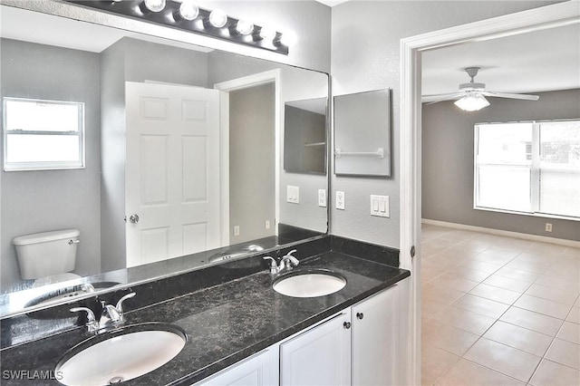 4016 35th St SW, Lehigh Acres, FL 33976 - full bathroom featuring double vanity, toilet, tile patterned floors, and a ceiling fan