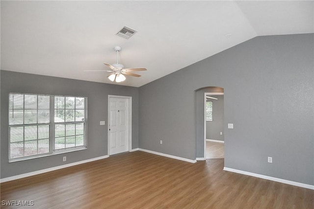 4016 35th St SW, Lehigh Acres, FL 33976 - empty room with arched walkways, ceiling fan, lofted ceiling, wood finished floors, and baseboards