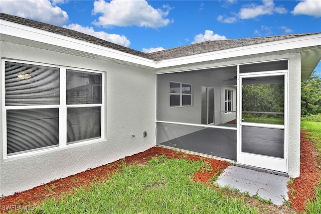 4016 35th St SW, Lehigh Acres, FL 33976 - back of house with a sunroom and stucco siding