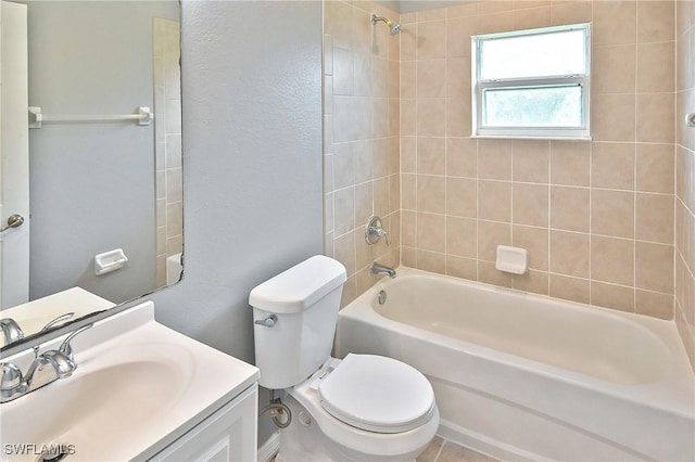 4016 35th St SW, Lehigh Acres, FL 33976 - bathroom with bathtub / shower combination, toilet, vanity, and a textured wall