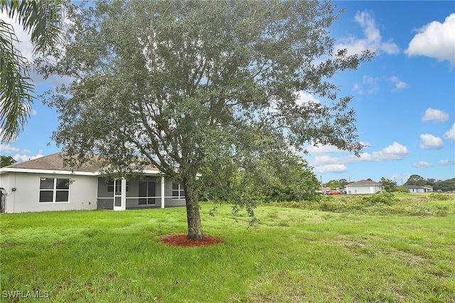 4016 35th St SW, Lehigh Acres, FL 33976 - view of grassy yard featuring a sunroom