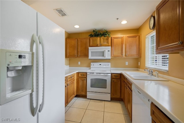 12021 Rock Brook Run Unit 2106, Fort Myers, FL 33913 - kitchen with white appliances, light countertops, light tile patterned flooring, and brown cabinets