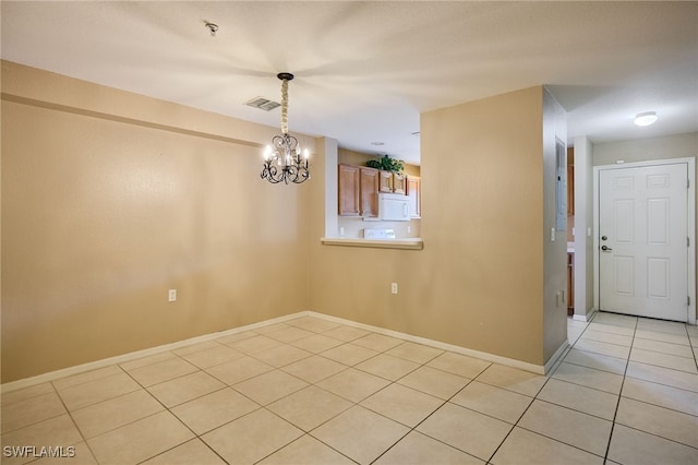 12021 Rock Brook Run Unit 2106, Fort Myers, FL 33913 - spare room featuring light tile patterned floors, a chandelier, and a pendent fire sprinkler