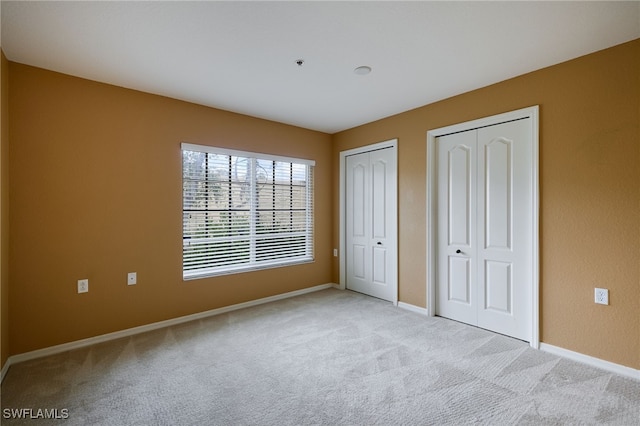 12021 Rock Brook Run Unit 2106, Fort Myers, FL 33913 - unfurnished bedroom with multiple closets and carpet