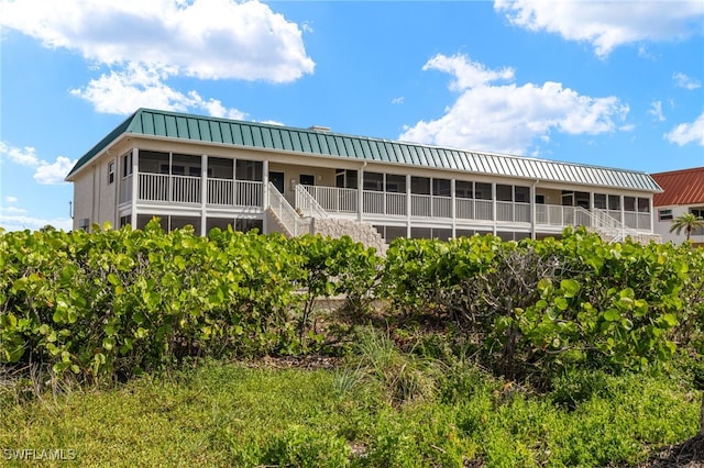 827 E Gulf Dr Unit C6, Sanibel, FL 33957 - back of property with a metal roof and stairs