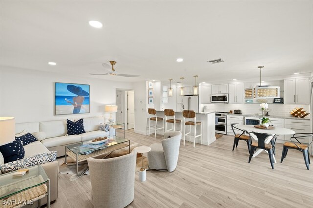 827 E Gulf Dr Unit C6, Sanibel, FL 33957 - living room featuring recessed lighting, light wood-style flooring, ceiling fan, and beverage cooler