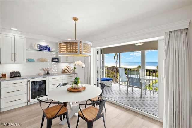 827 E Gulf Dr Unit C6, Sanibel, FL 33957 - dining room with wine cooler, a dry bar, a water view, light wood finished floors, and recessed lighting