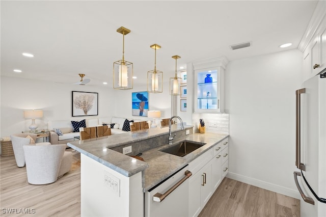 827 E Gulf Dr Unit C6, Sanibel, FL 33957 - kitchen featuring white appliances, a peninsula, light wood finished floors, white cabinetry, and light stone countertops