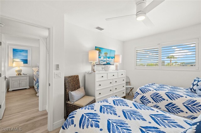 827 E Gulf Dr Unit C6, Sanibel, FL 33957 - bedroom with light wood-style floors and a ceiling fan