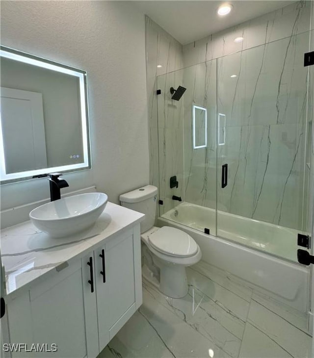 6010 Acorn Cir, Labelle, FL 33935 - full bathroom with combined bath / shower with glass door, vanity, toilet, and marble look tile flooring