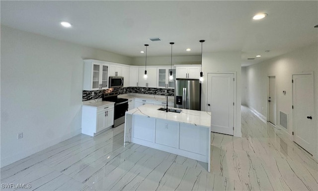 6010 Acorn Cir, Labelle, FL 33935 - kitchen with appliances with stainless steel finishes, a sink, recessed lighting, glass insert cabinets, and an island with sink
